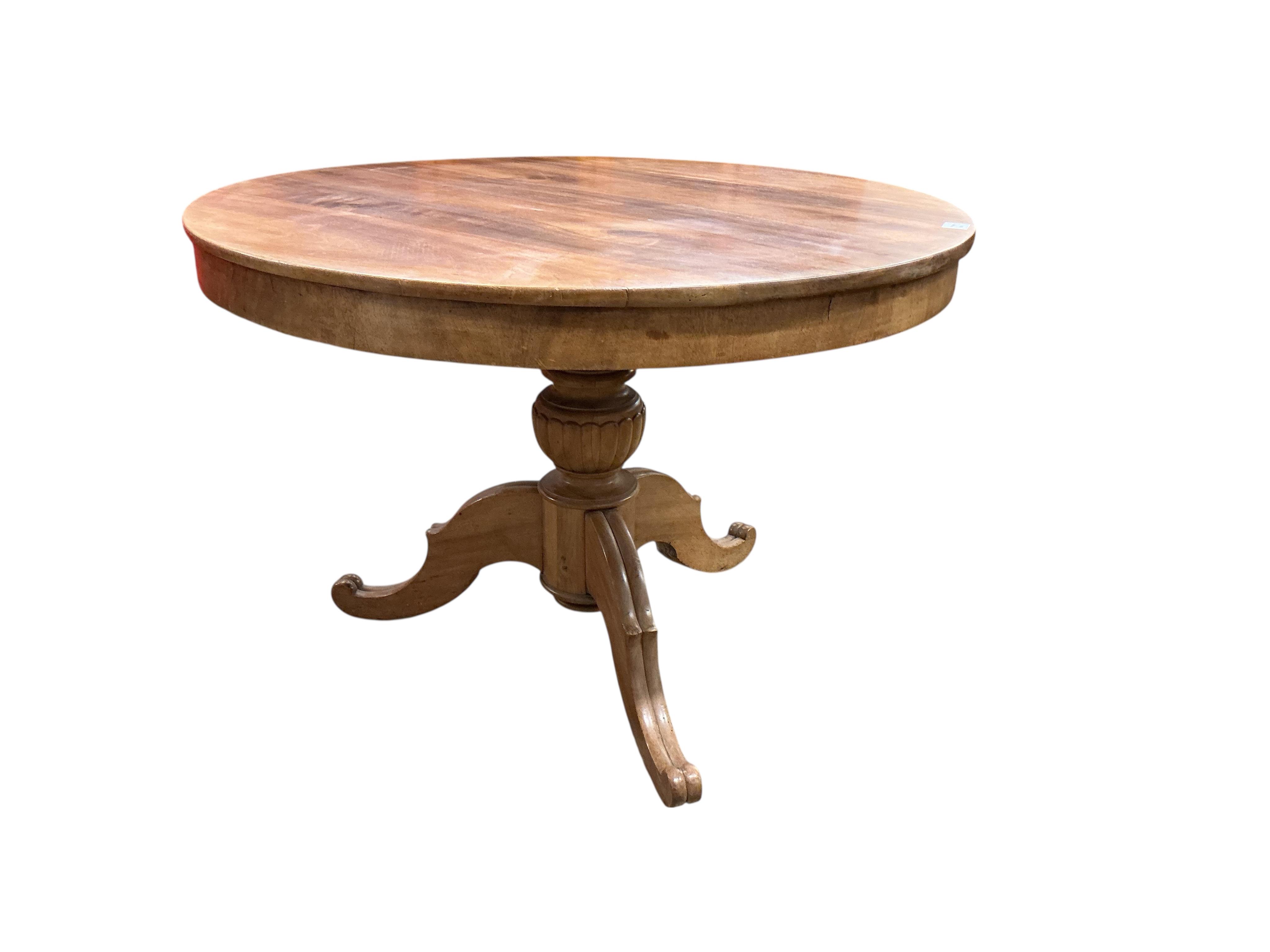 A Swedish circular walnut breakfast table, diameter 107cm, height 76cm together with four dining chairs, one with arms